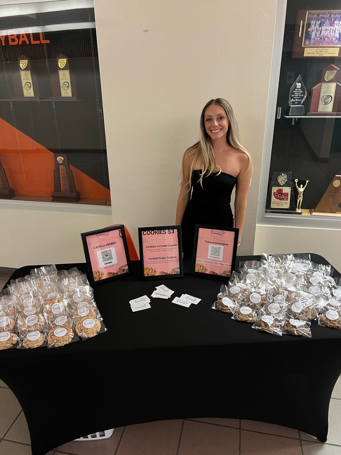 Allyson at her booth with cookies packaged for sale